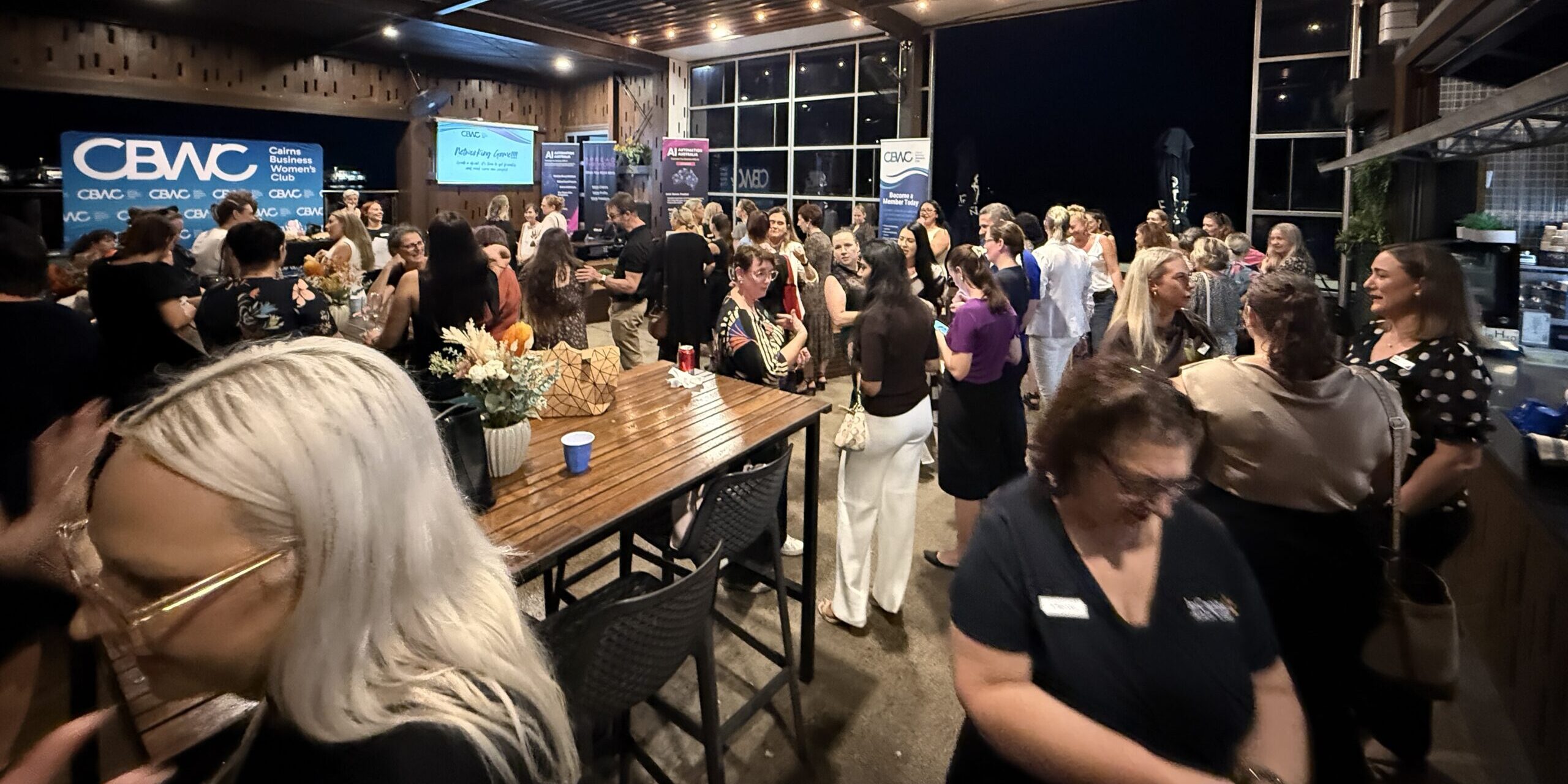 Business owners networking at a professional event in Cairns, highlighting the role of relationships in business growth